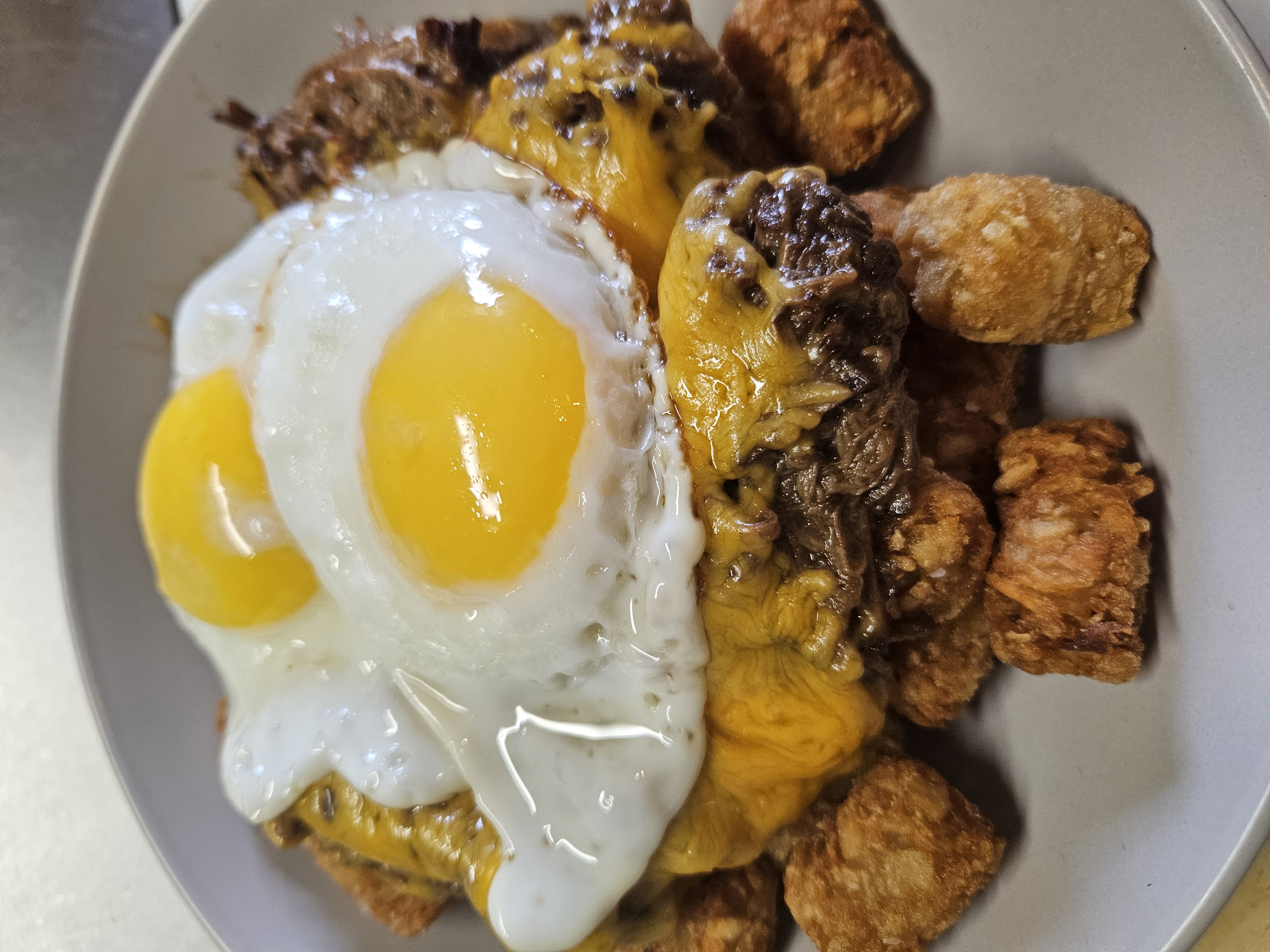 Breakfast Bowl at Nerdateria — egg with brisket and tater tots