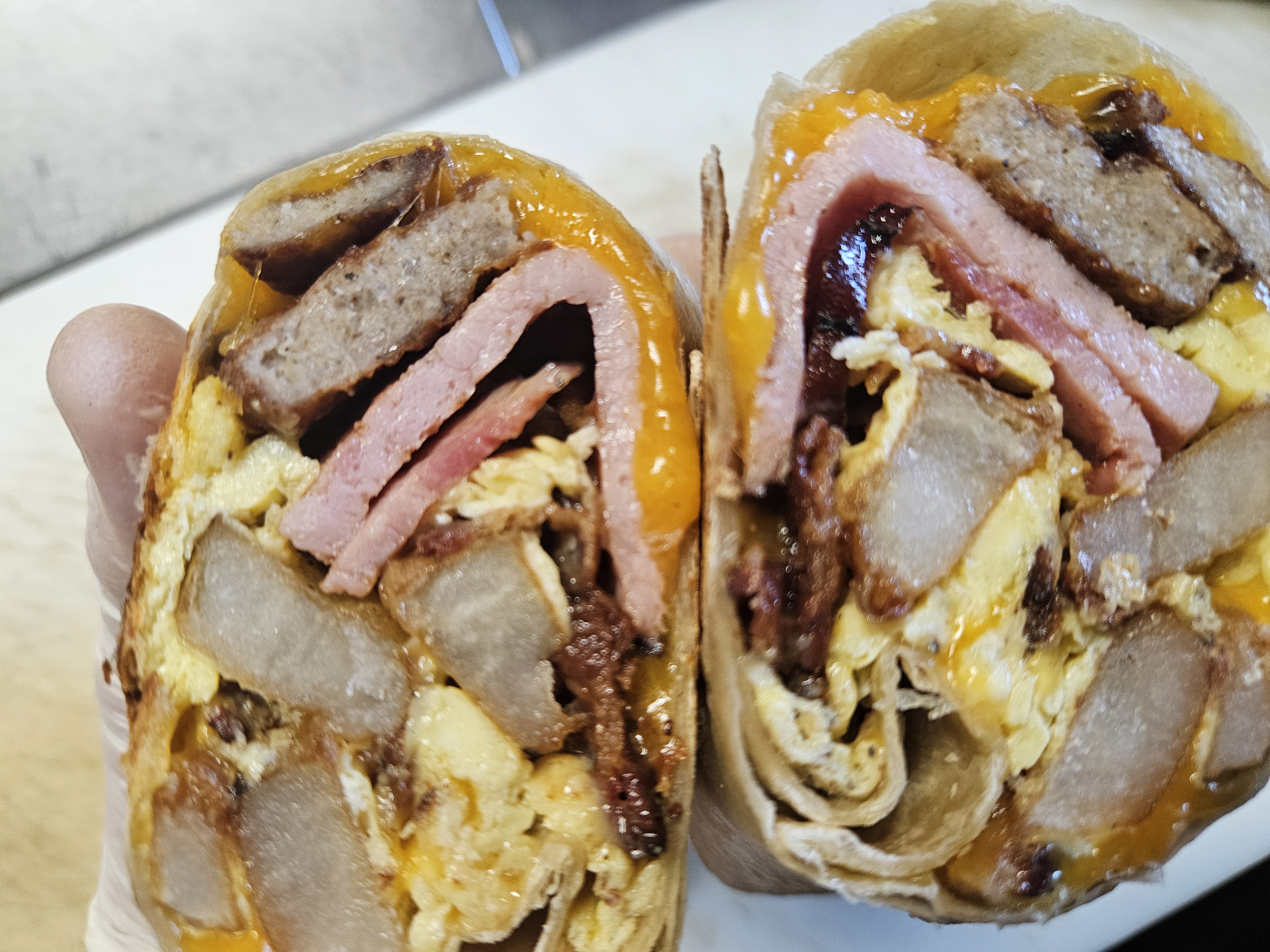 Carnivore Breakfast Burrito at Nerdateria — ham, sausage, bacon, egg and cheddar