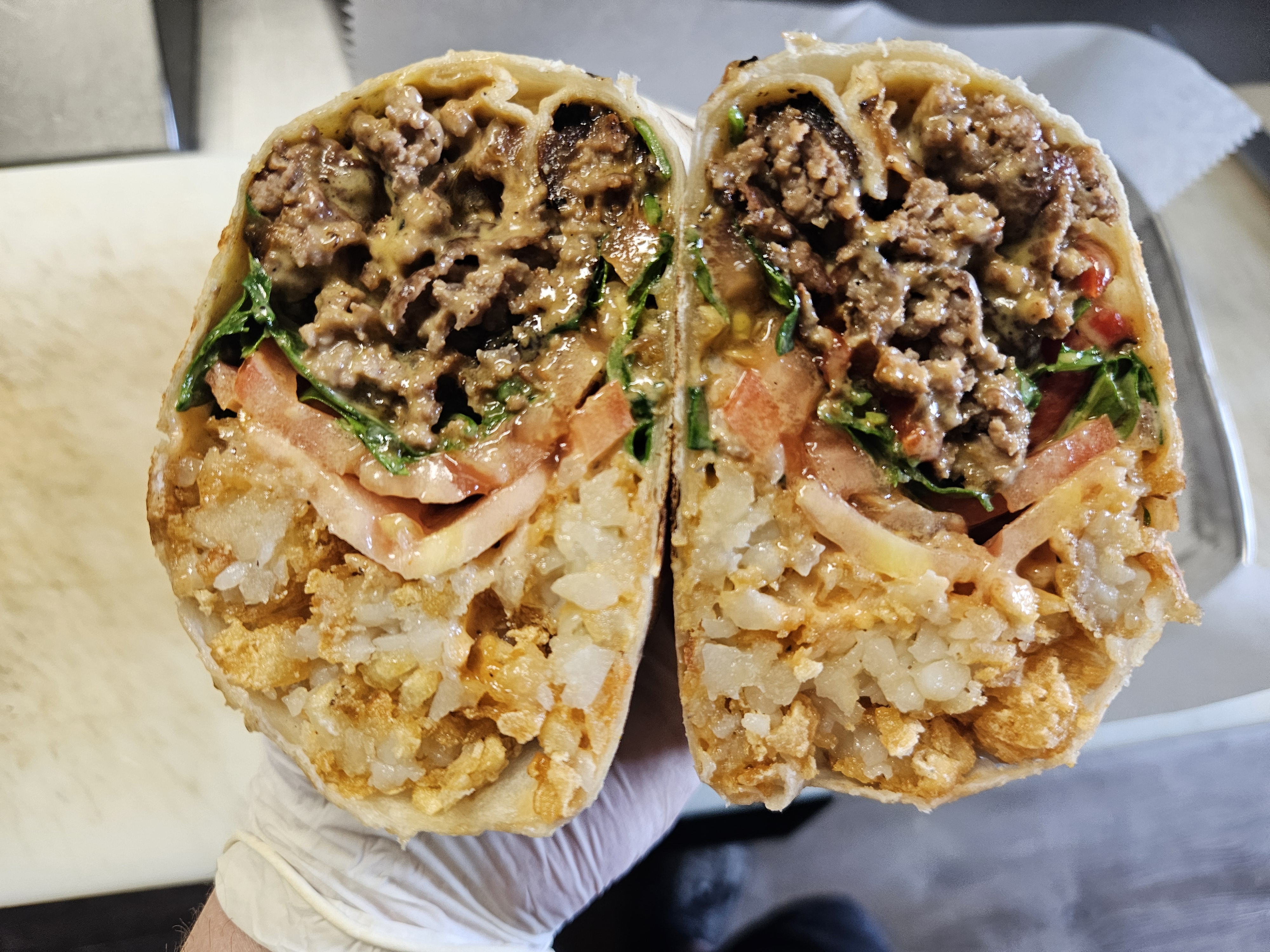 Chopped Cheese Burrito at Nerdateria — tater-tot stuffed with ground beef and cheese
