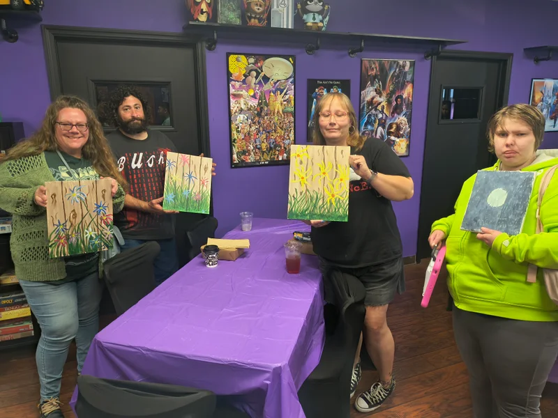 Participants with completed paintings at Nerdateria